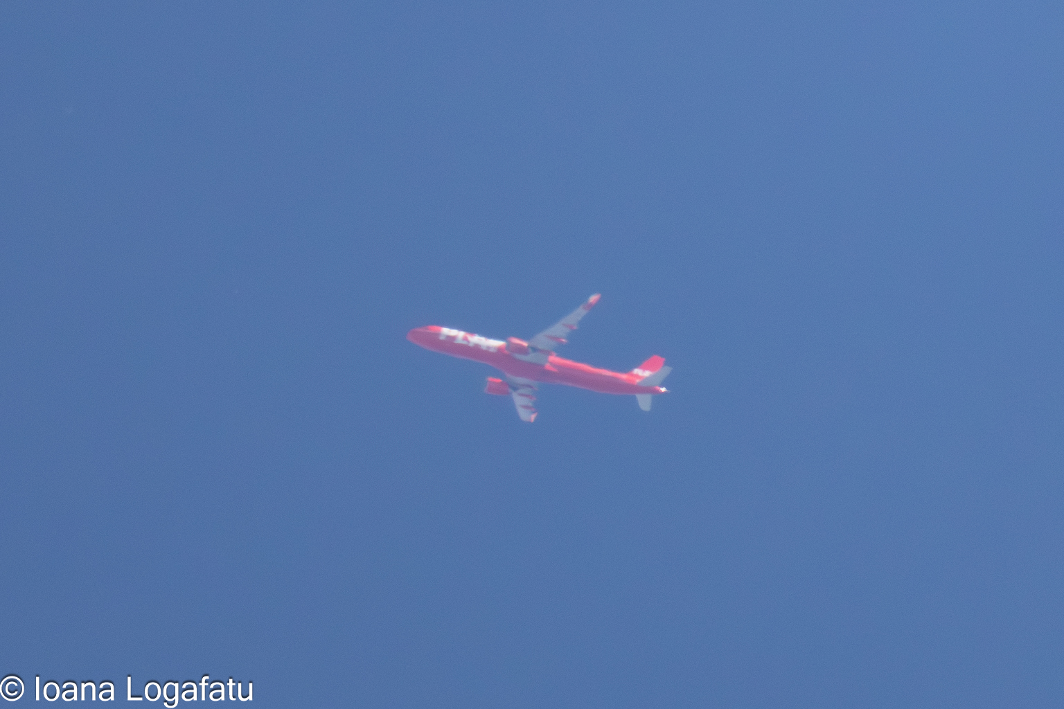 Airplane gliding through a serene blue sky